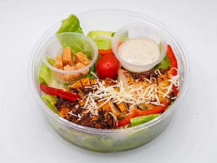 Grilled chicken Caesar salad with croutons, parmesan and ranch dip